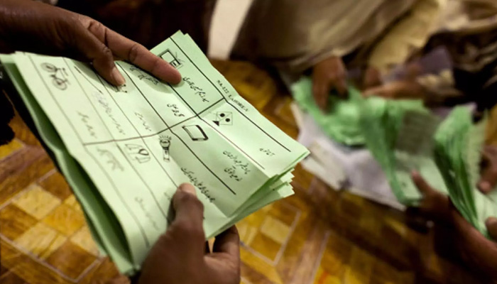 A person holding ballot pappers at a polling station during an election in Pakistan in this undated image. — Reuters