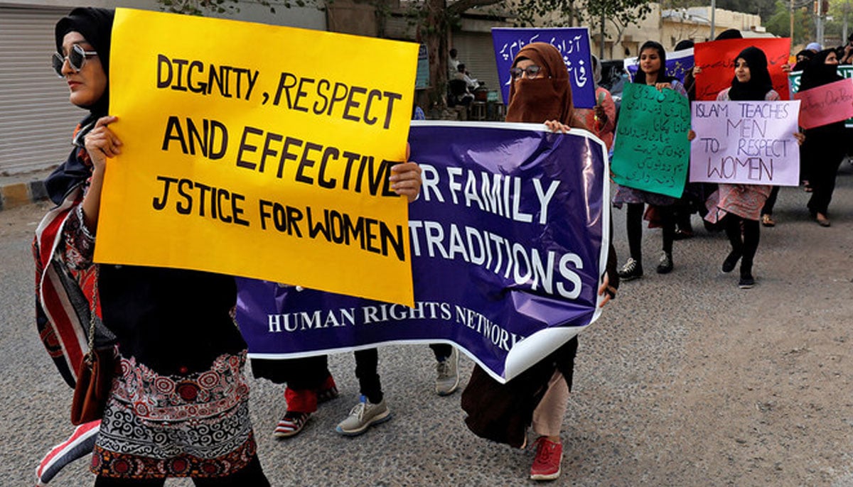 Women carry signs as they take part in a march demanding equal rights, ahead of International Womens Day in Karachi on March 6, 2020. — Reuters