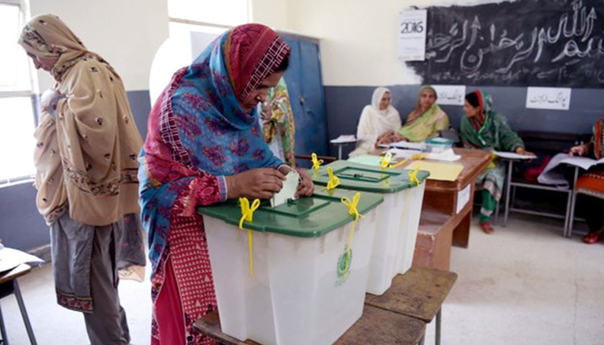 A woman casts her vote during Pakistans general election at a polling station in Islamabad on July 25, 2018. — AFP