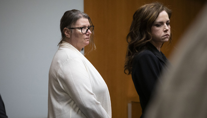 Jennifer Crumbley, the mother of Oxford school shooter Ethan Crumbley (L), stands with her attorney in Oakland County Circuit Court amid the start of deliberations on four counts of involuntary manslaughter on February 5, 2024, in Pontiac, Michigan. — AFP