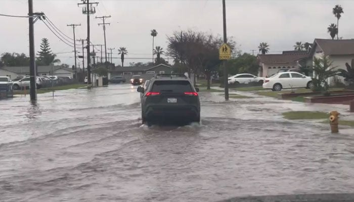 The screenshot from a video released on Feb 6, 2024, shows a waterlogged street inBuena Park Area of California. — x/BPW_SERVICES714