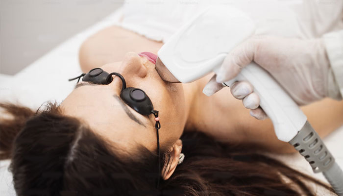 A woman getting a laser skin treatment. — Unsplash