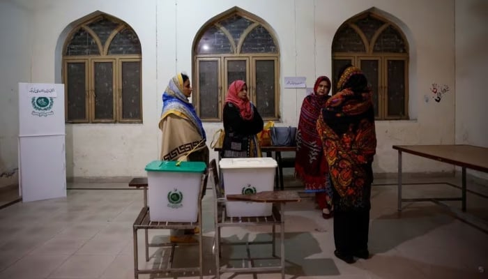 Staff are briefed inside a polling station on the day of the general election, in Lahore, on February 8, 2024. —Reuters