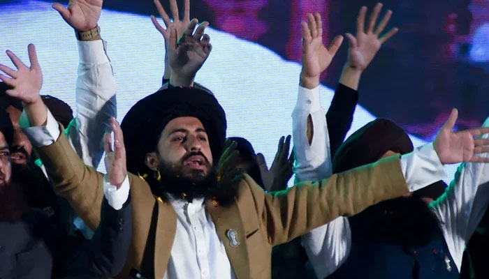Saad Hussain Rizvi (C), leader of Tehreek e Labbaik Pakistan (TLP) waves to party supporters during an election campaign rally in Karachi on February 4, 2024. — AFP