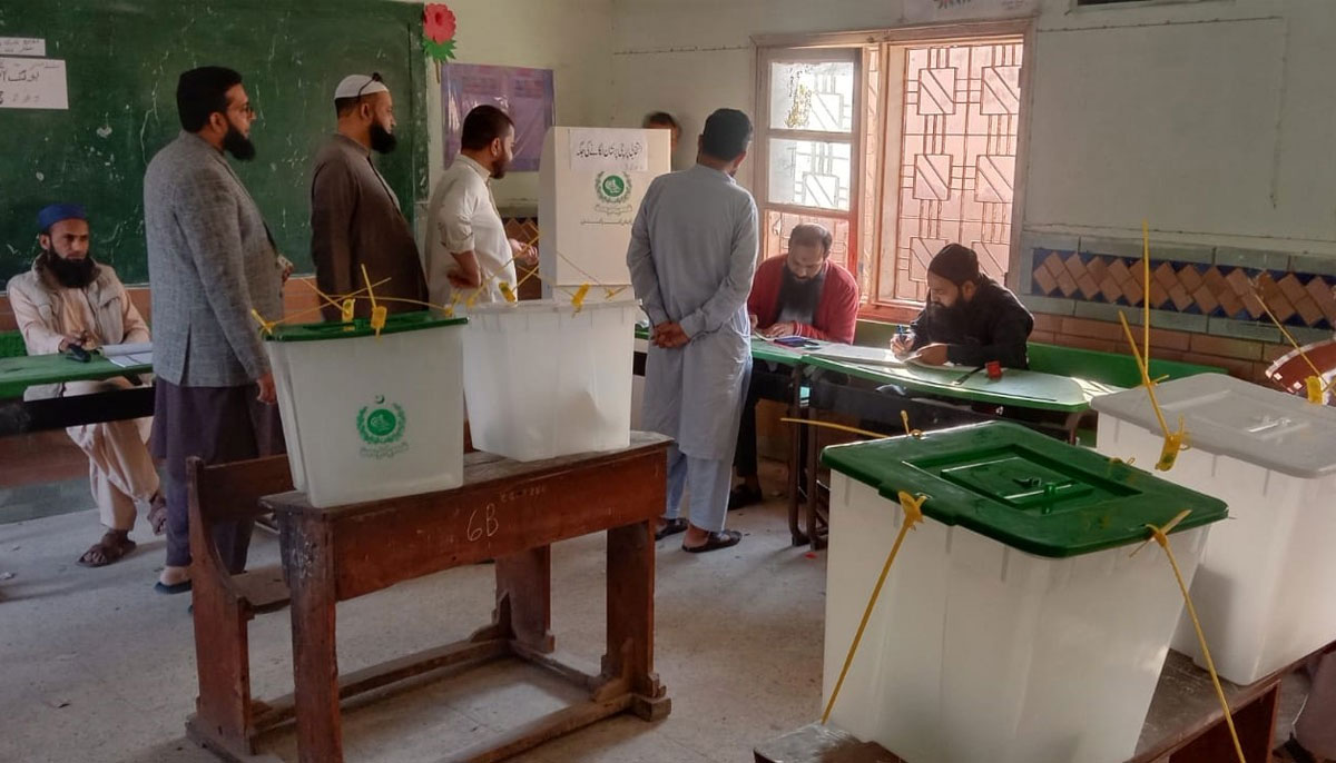 The picture shows people waiting in line to cast vote. — Geo.tv