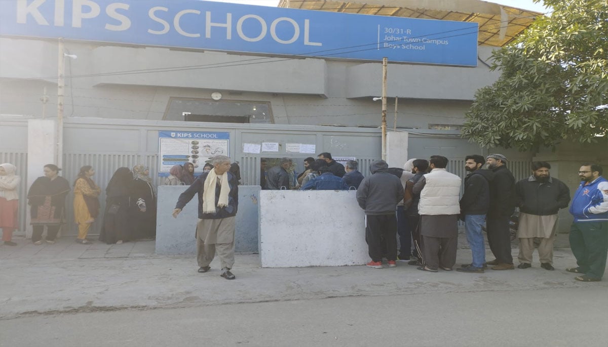 The picture shows people standing outside polling station. — X/@PTI