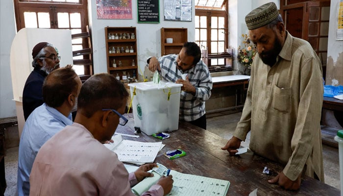 A man retrives his balloting paper, after he put it in the wrong balloting box, after casting his vote during the general election in Karachi, Pakistan February 8, 2024. — Reuters