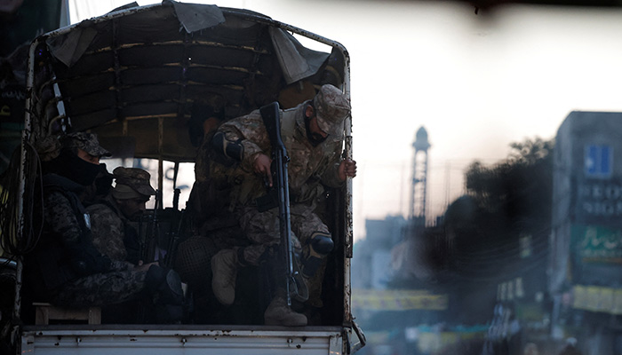 An army personnel gets out of a vehicle near a polling station on the day of the general election, in Lahore, February 8, 2024. — Reuters