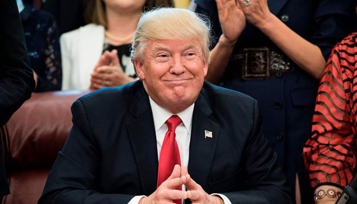 Former president Donald Trump smiling. — AFP/File