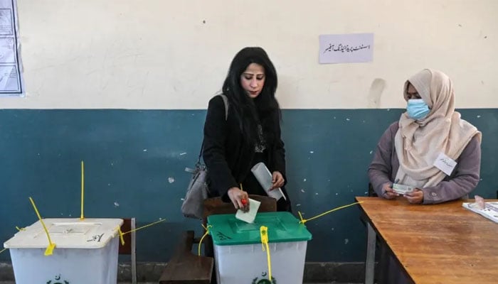 A woman casts her vote at a polling station during Pakistans national election in Lahore on February 8, 2024. — AFP