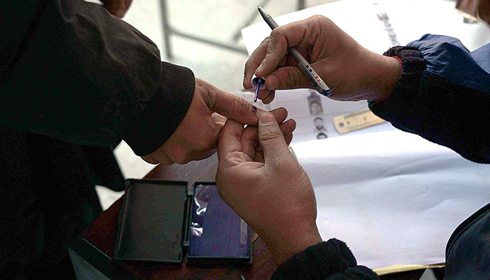 A voter marks a voter's thumb before issuing a ballot paper at a polling station in Rawalpindi during the general election on February 8, 2024. — APP