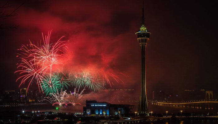 Fireworks explode near the Macau Tower marking the last day of the Chinese New Year festivities in the Lunar calendar, in Macau on February 5, 2023. — AFP