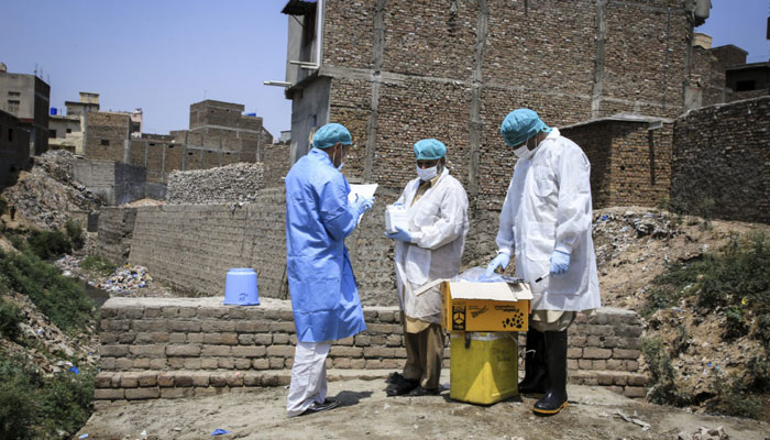 The poliovirus sampling team collects samples from sewage in Safdarabad, Punjab, Pakistan. — Global Polio Eradication Initiative