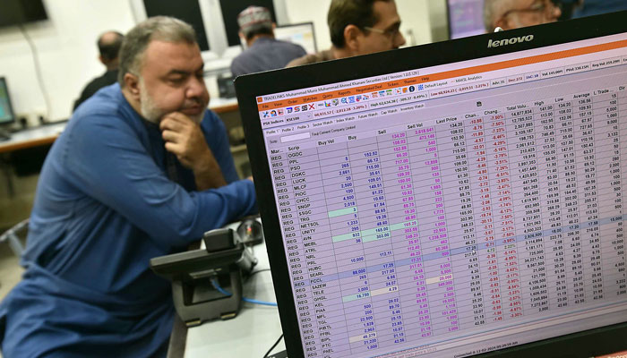 Stock brokers monitor their screen in this undated picture. — INP/File