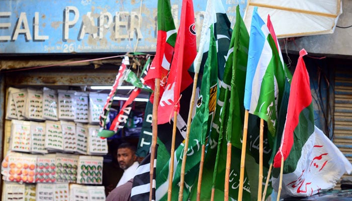 Flags of political parties are displayed outside a shop in this undated picture. — PPI/File