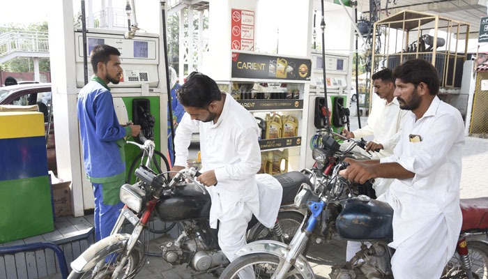 A petrol station attendant fills the tank of a motorcycle at a petrol pump in Rawalpindi on October 10, 2024. — Online