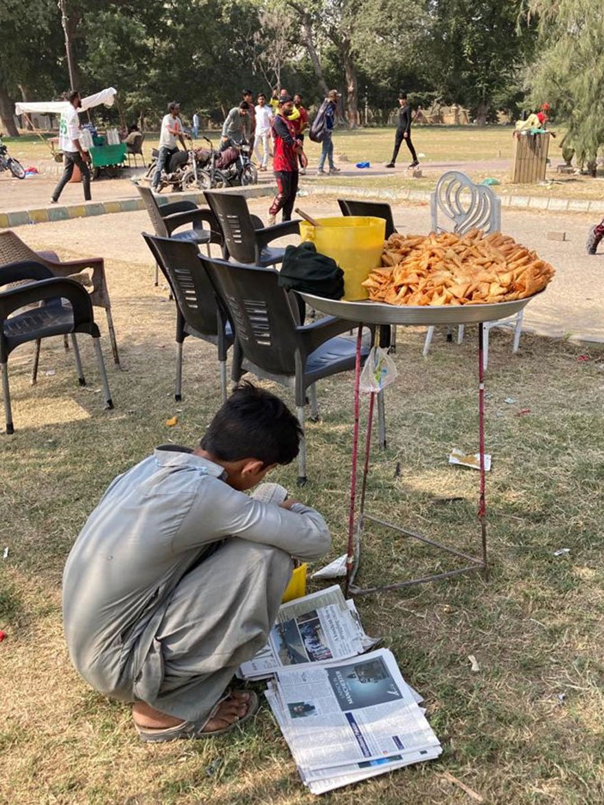 A young boy sits next to his snacks stall at the Frere Hall. — Photo by author