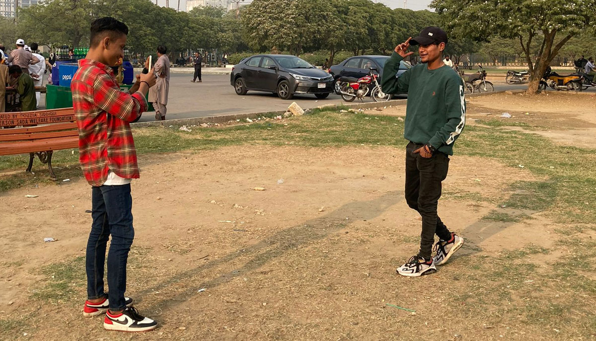 Two boys make TikTok videos inside the Frere Hall gardens. — Photo by author