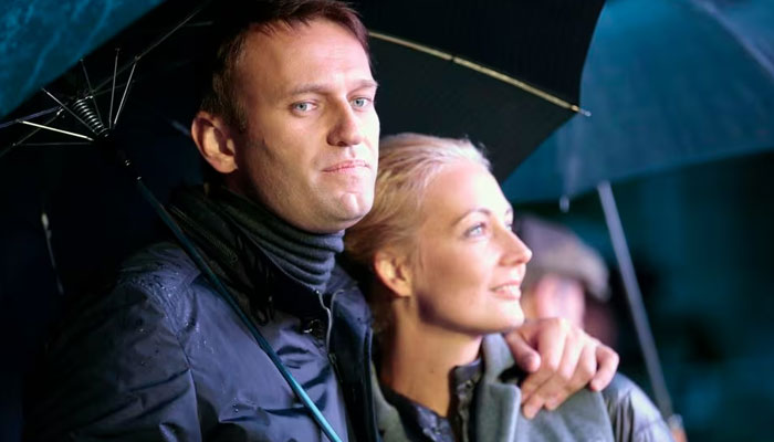 Alexei Navalny and his wife Yulia look on during a support rally in central Moscow September 6, 2013. —Reuters