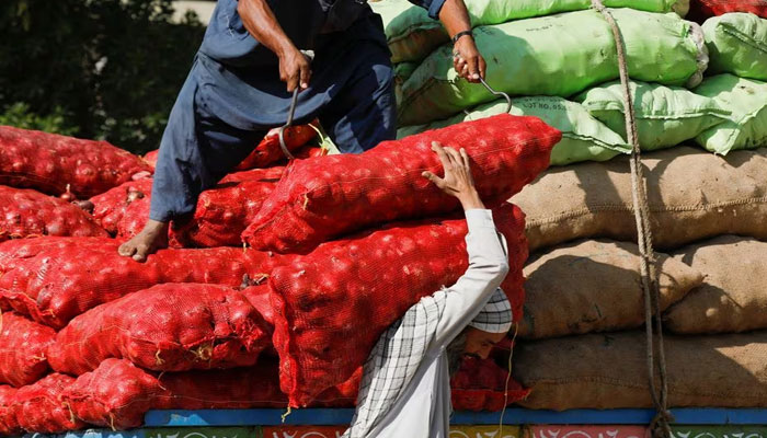 Labourers unload sacks of onion from a truck to supply at a market in Karachi, Pakistan February 1, 2023. — Reuters