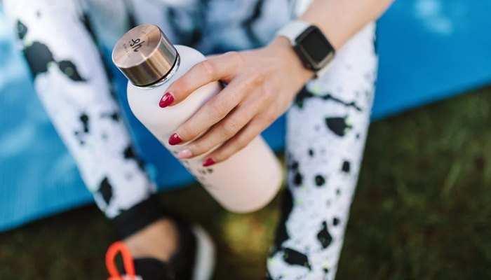 A representational image of a person holding a water bottle. — Pexels
