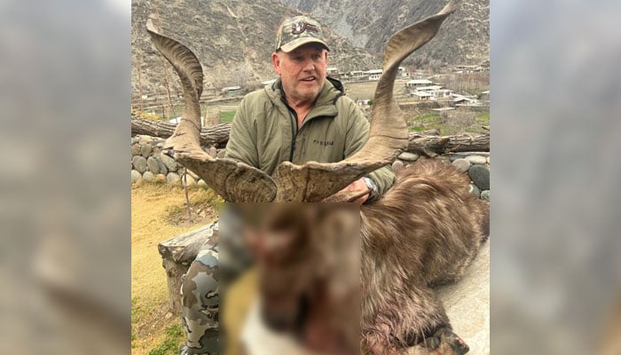 US citizen Robert Myles Hall poses with the hunted Markhor. — Facebook/Chitral Wildlife Division