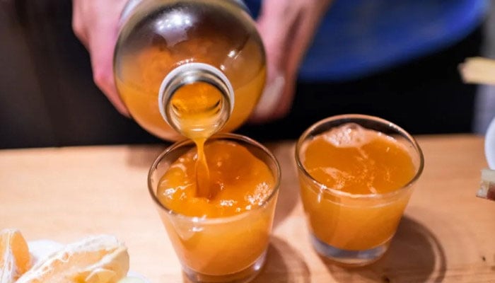 Kombucha being poured into a shot glass. — Medical News Today via Pinterest
