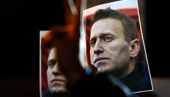 A person gestures in front of portraits of Russian opposition leader Alexei Navalny as people attend a protest and vigil held in front of the Russian embassy following the death of Navalny, in Kappara, Malta, February 19, 2024. — Reuters