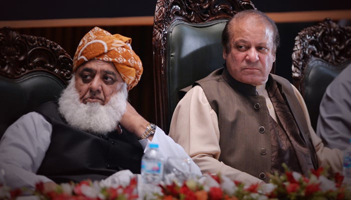 JUI-F chief Maulana Fazl-ur-Rehman (left) with PML-N supremo and former prime minister Nawaz Sharif during a seminar in Islamabad on April 17, 2018. — AFP