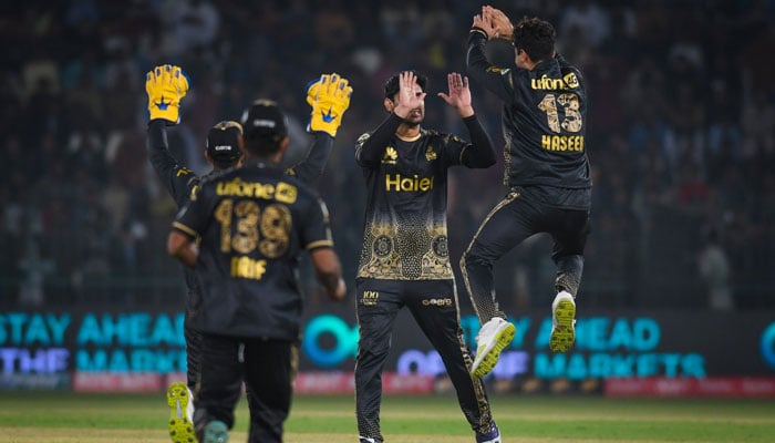 Peshawar Zalmi’s players celebrate victory at the Multan stadium. — PSL