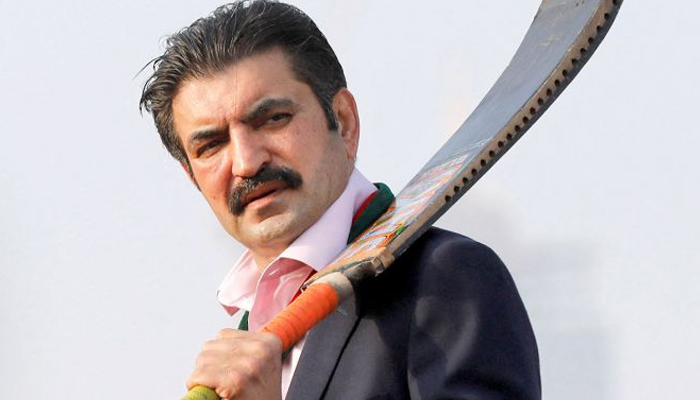 Imran Khans lawyer Sher Afzal Khan Marwat holds a cricket bat while speaking to supporters at a PTI rally in Karachi, January 14, 2024. — Reuters