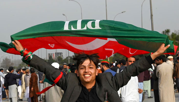 The picture shows a young PTI supporter. — AFP/File