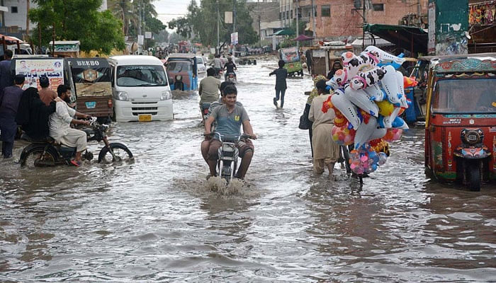 In this undated photo, a road is seen submerged under rainwater in Karachi. — APP
