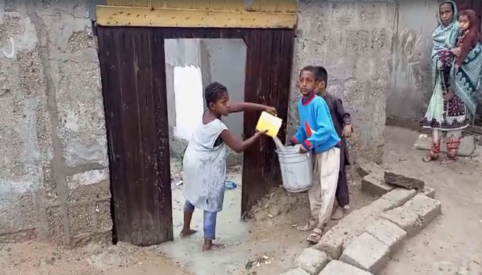 The picture shows kids removing rainwater from their house in Gwadar, Balochistan on February 28, 2024. — Provided by the reporter