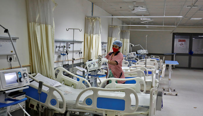 A staff member cleans medical equipment inside a ward that is set up to treat people infected with the Omicron coronavirus variant at the Civil Hospital in Ahmedabad, India, December 6, 2021. — Reuters