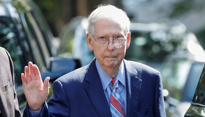 US Senate Leader Mitch McConnell (R-KY) waves as he leaves his Washington house to return to work at the US Senate. —Reuters