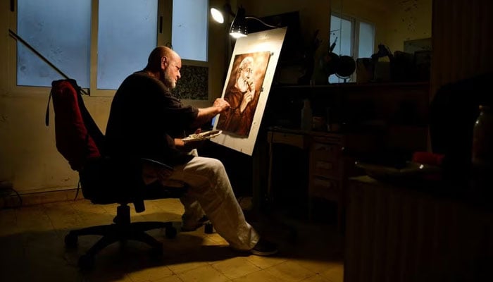 Artist Milton Bernal poses for a photo while working in his studio in Havana, Cuba, February 24, 2024.—Reuters