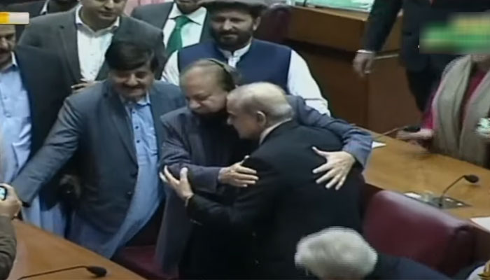 PM-elect Shehbaz Sharif hugs his brother PML-N supremo Nawaz Sharif after being announced winning the election for the  premier