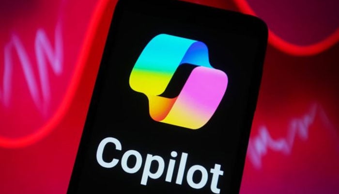 This image shows the Copilot logo displayed on a phone screen. — Unsplash