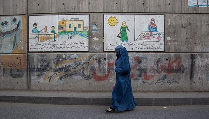 A woman walks past a street in Kabul in September 2021. — Tasnim News Agency/File