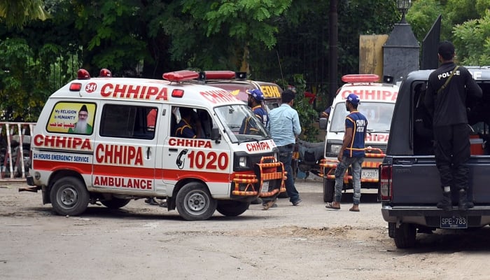 Ambulances are parked outside the Karachi police headquarters on August 2, 2022. —Online