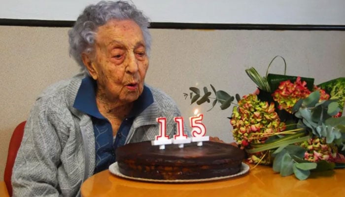 Maria blows candles on a cake on her 115th birthday. — News Flash