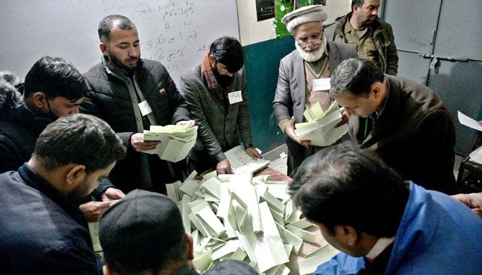 Election officials counting votes in Rawalpindi after culmination of polling time on February 8, 2024. — APP