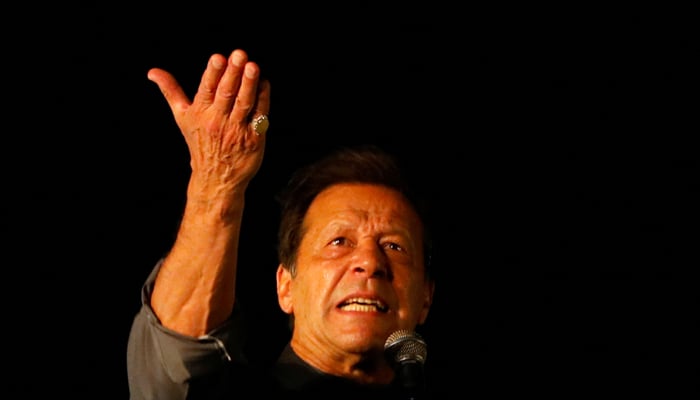 PTI founder Imran Khan gestures as he addresses supporters during a rally, in Karachi, April 16, 2022. — Reuters