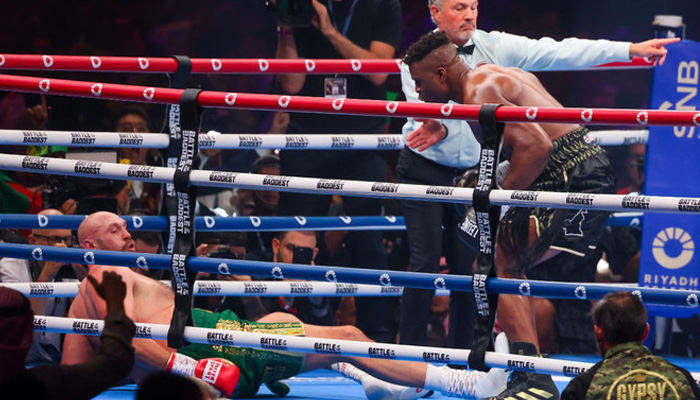 Britains Tyson Fury (left) falls on the ground as he fights against Cameroonian-French Francis Ngannou during their heavyweight boxing match in Riyadh early on October 29, 2023. — AFP