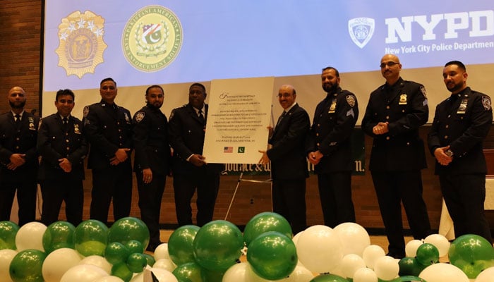 Ambassador Masood Khan stands alongside NYPD police officers of Pakistani descent. — Embassy of Pakistan