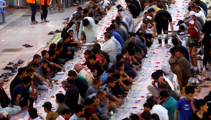 Iraqi Muslims gather to break their fast during a free collective iftar on a street during the holy fasting month of Ramadan in Najaf, Iraq April 18, 2021. — Reuters/File
