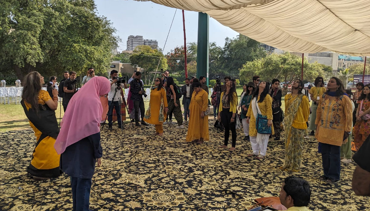 Sheerma Kirmani conducting a dance class before the start of official proceedings of Aurat March at Frere Hall Karachi on March 8, 2024. — Author
