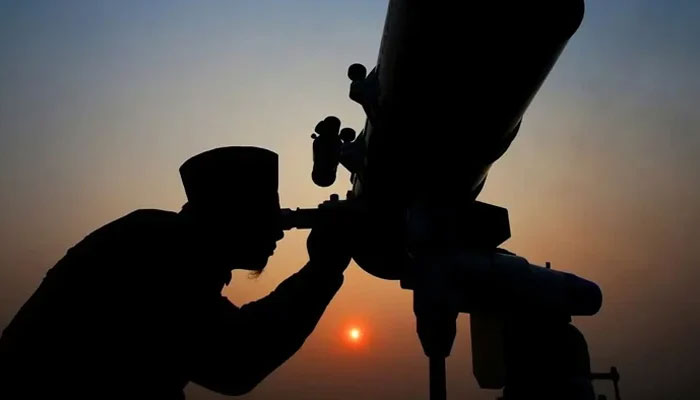 A person using telescope to sight the moon. — Reuters/File