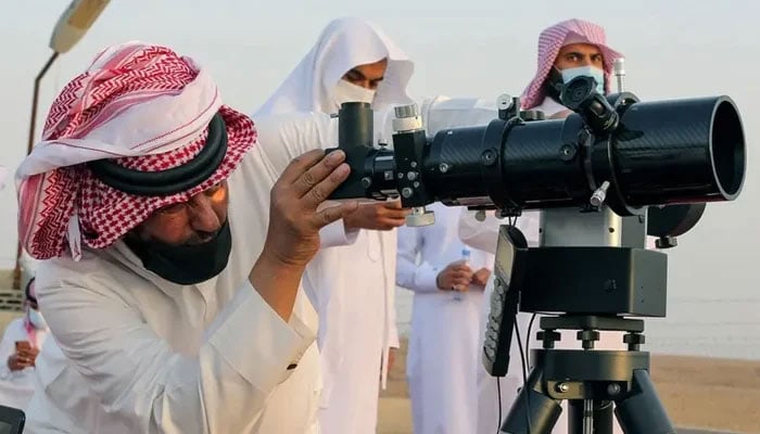 A member of the moon sighting committee looks through a telescope to view the moon ahead of Ramadan to mark the beginning of the holy fasting month, near Riyadh, Saudi Arabia, on April 12, 2021. — Reuters